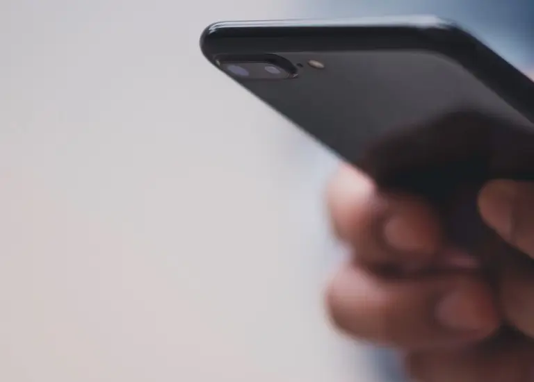 a close up of a person holding a cell phone