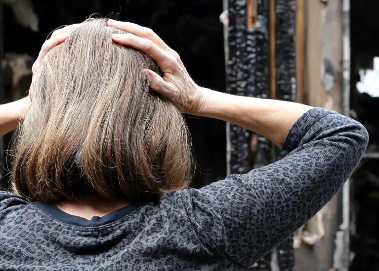 A person with their hands on their head