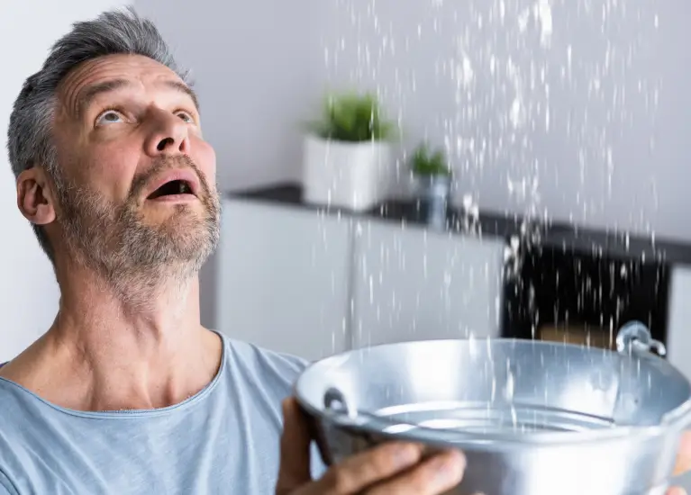 A man holding a bowl of water
